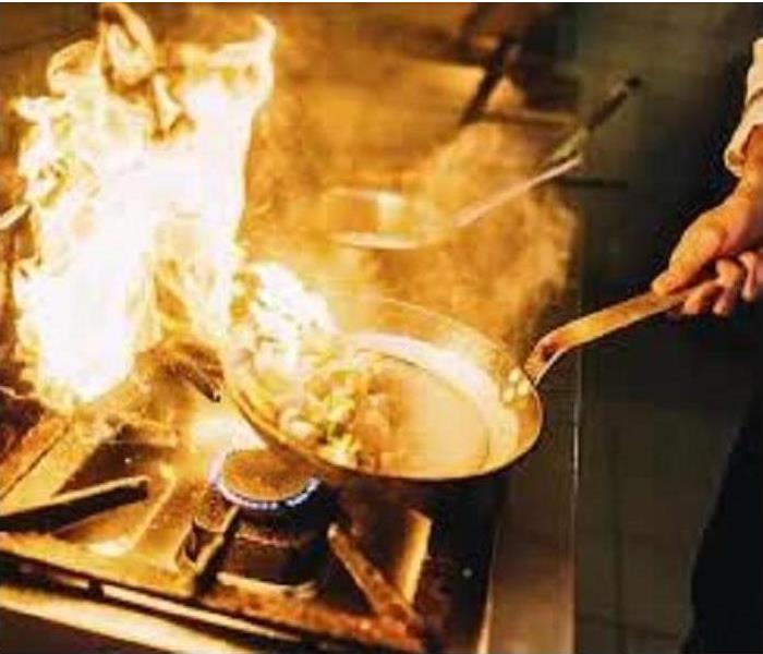 Chef cooking with flames